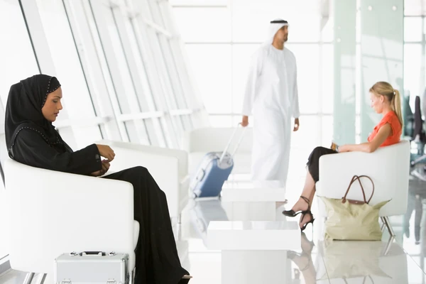 Traveller arriving with luggage for a pre-arranged Abu Dhabi airport transfer
