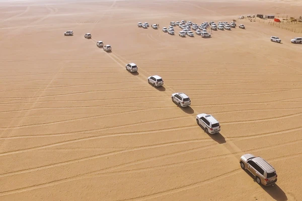 Four-wheel-drive vehicle dune bashing in the Al Khatim desert