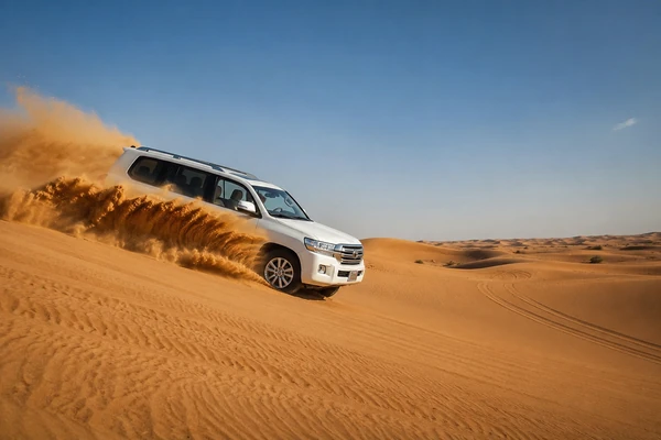 Four-wheel-drive vehicle dune bashing in the Abu Dhabi desert