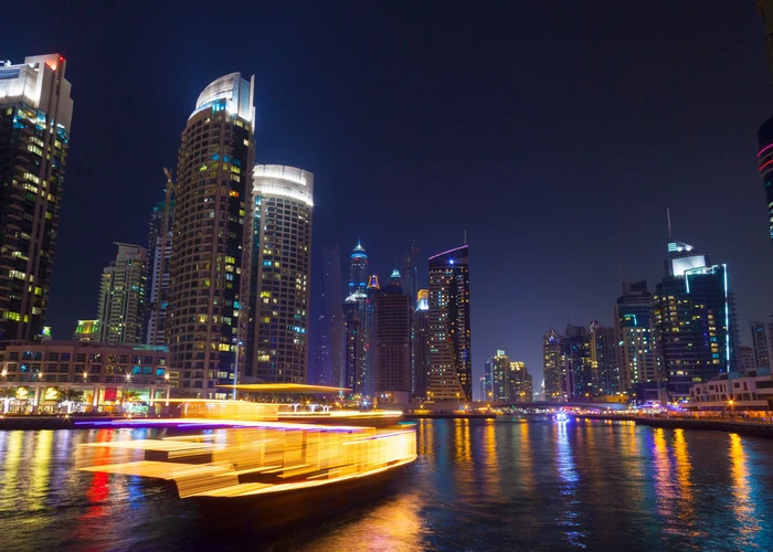Traveller looking out over the Abu Dhabi marina and skyline at dusk