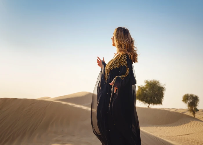 Traveller standing on a dune in the cool morning light near Abu Dhabi